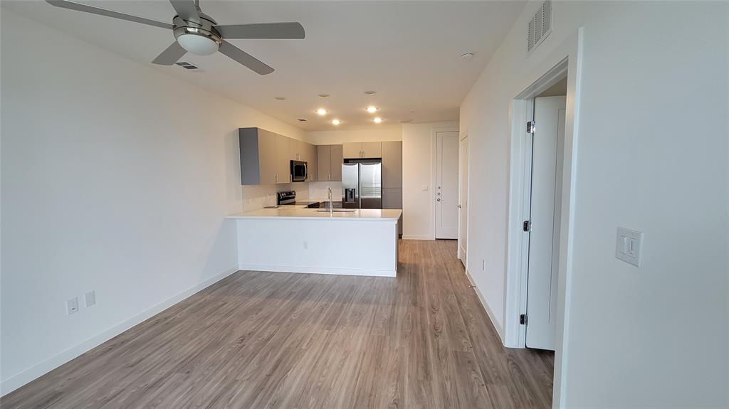 4801 Springdale Road, Unit 1202 Austin, TX 78723 - Photo 5 of 15 a view of a kitchen with a sink and wooden floor