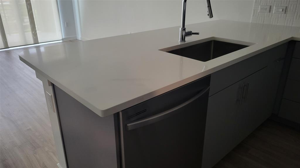 4801 Springdale Road, Unit 1202 Austin, TX 78723 - Photo 6 of 15 a close view of kitchen sink a microwave and refrigerator