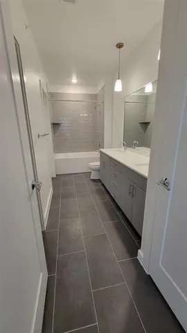 a bathroom with a bathtub and a toilet