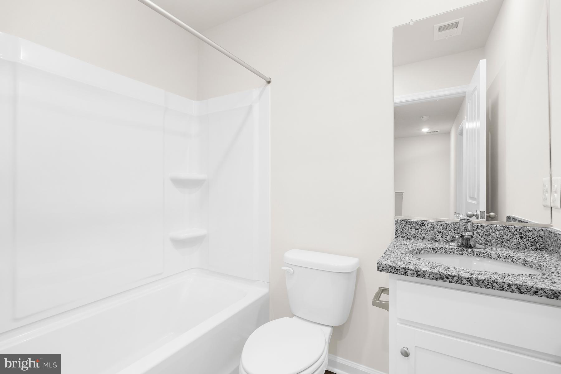 8155 Bartholomew Court Baltimore, MD 21206 - Photo 19 of 19 a bathroom with a granite countertop sink toilet and shower