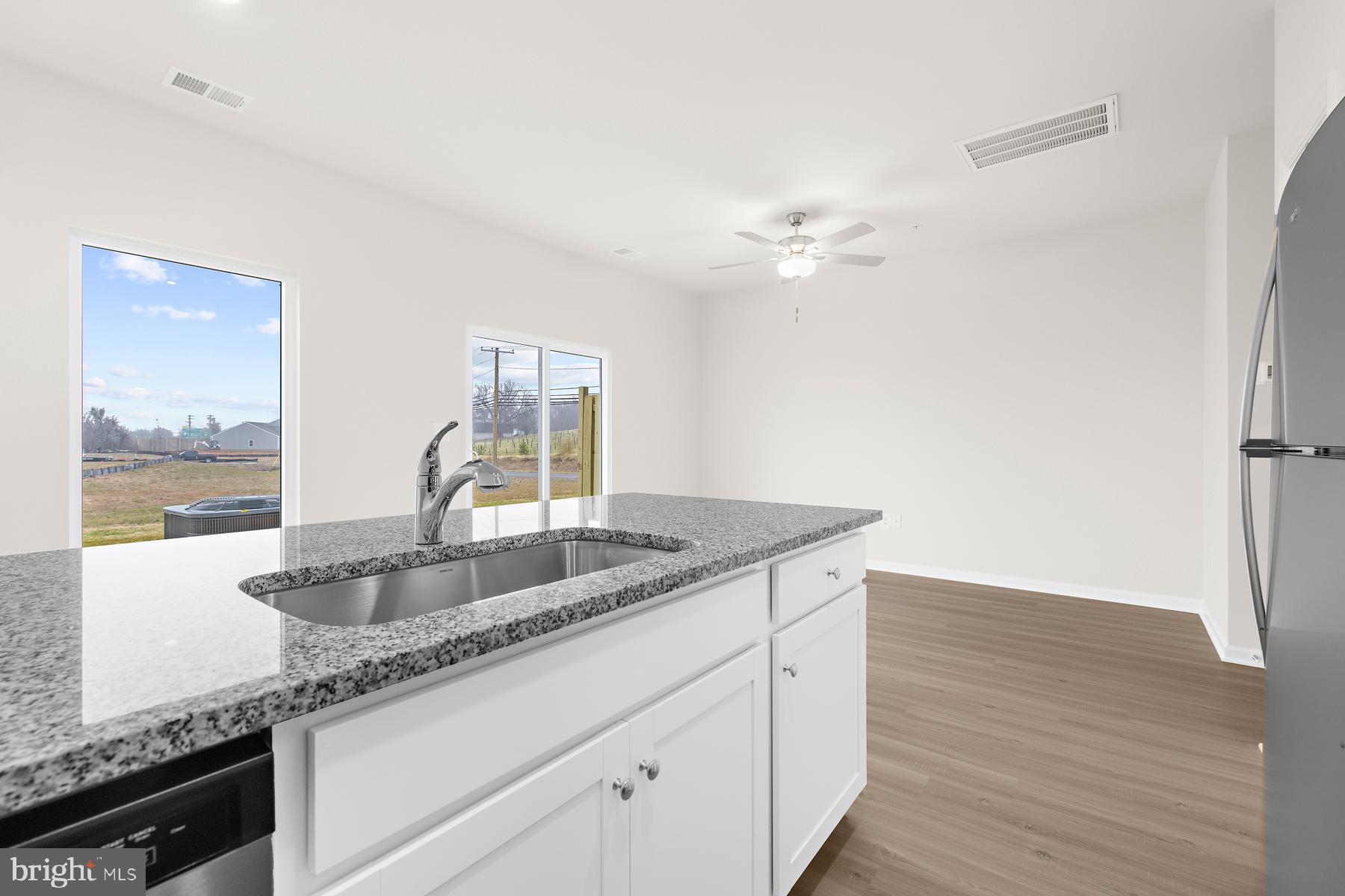 8155 Bartholomew Court Baltimore, MD 21206 - Photo 6 of 19 a kitchen with granite countertop a sink a counter space and stainless steel appliances