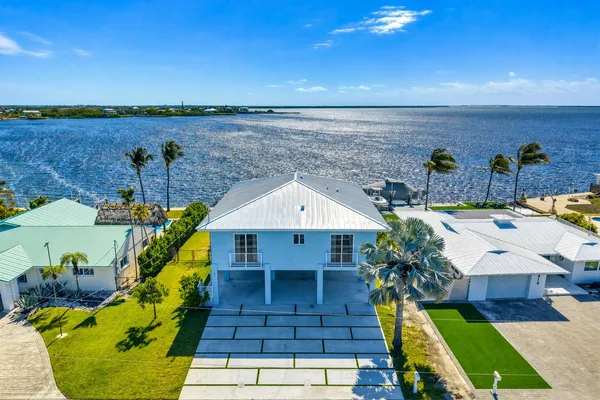 a aerial view of a house with swimming pool and a yard