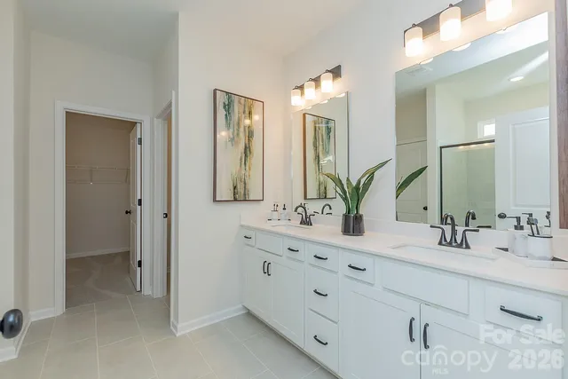 a bathroom with double vanity sinks and a mirror