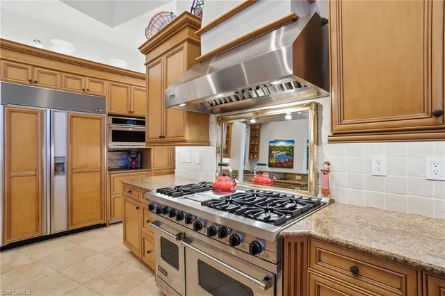 a kitchen with stainless steel appliances granite countertop a stove and a refrigerator