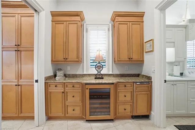 a kitchen with stainless steel appliances granite countertop a sink and a refrigerator