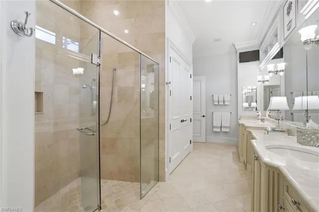 a bathroom with a double vanity sink mirror and shower