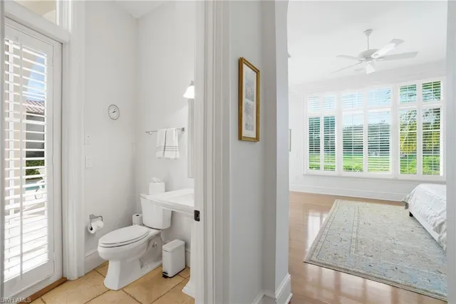 a bathroom with a toilet sink and a mirror