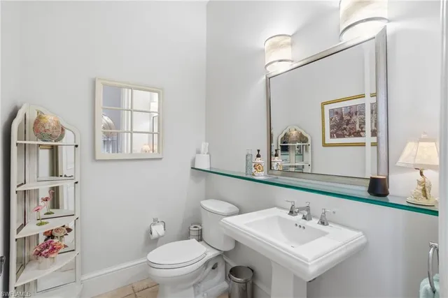 a bathroom with a sink toilet and a mirror