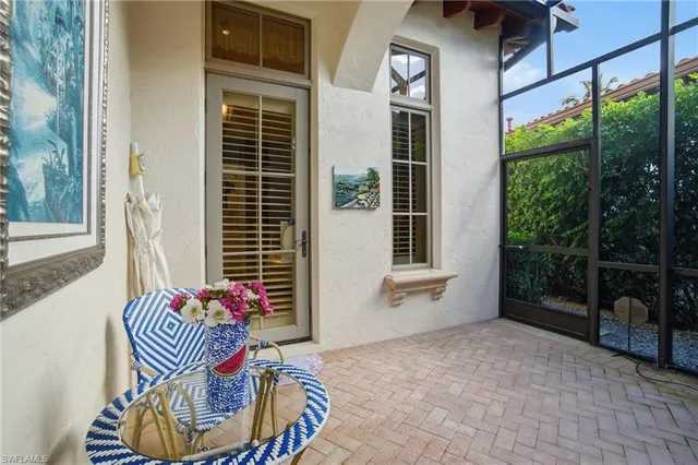 a balcony with table and chairs
