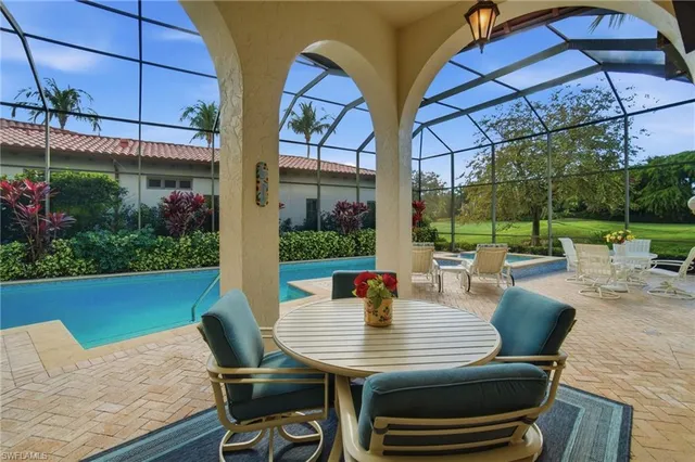 a view of a patio with table and chairs potted plants with wooden floor and fence