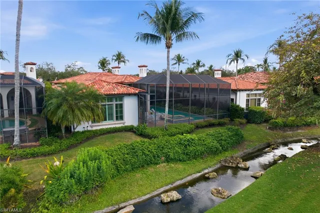 a view of a house with a yard and potted plants