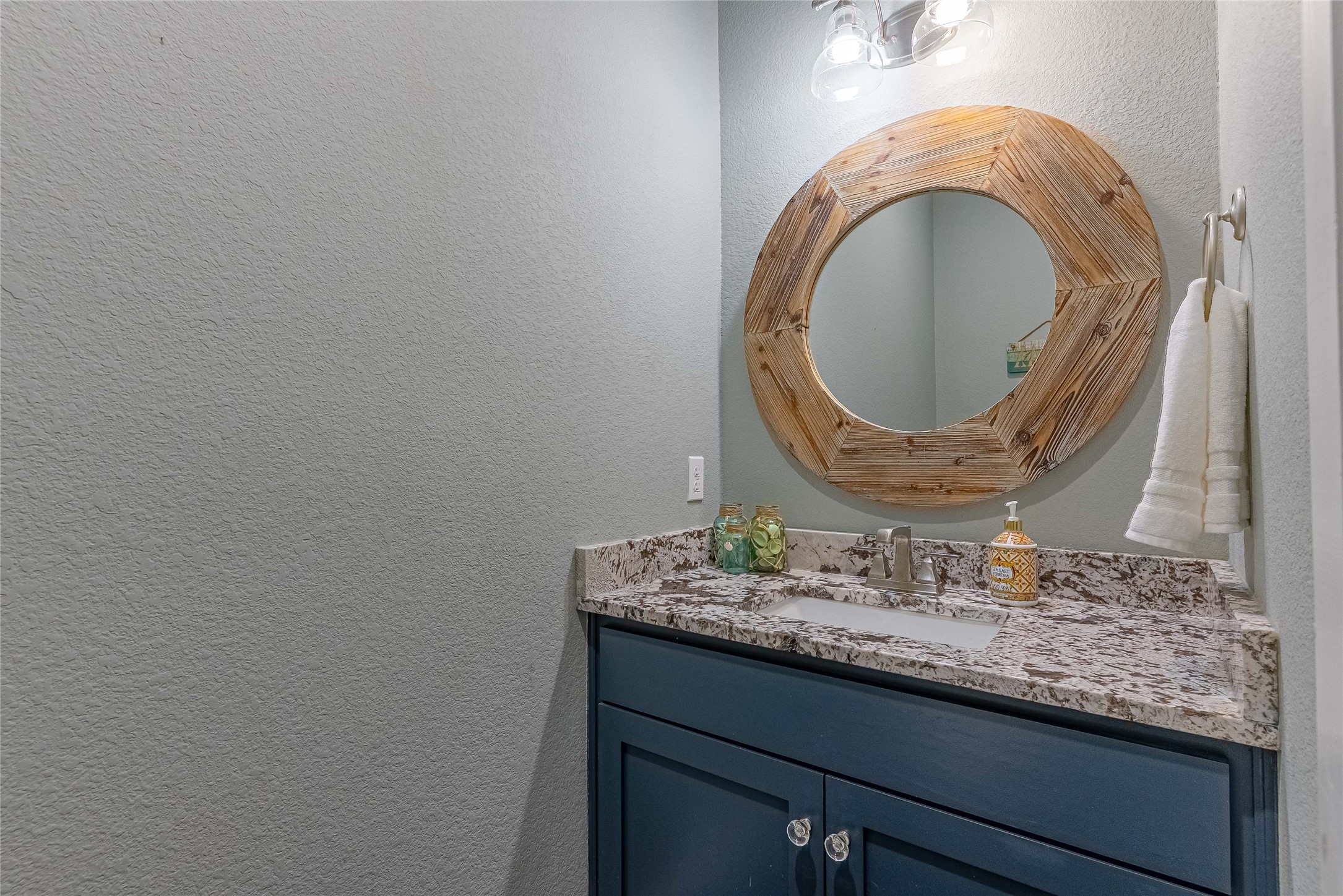 410 Summit Ridge Drive North Point Venture, TX 78645 - Photo 14 of 37 a bathroom with a granite countertop sink and a mirror