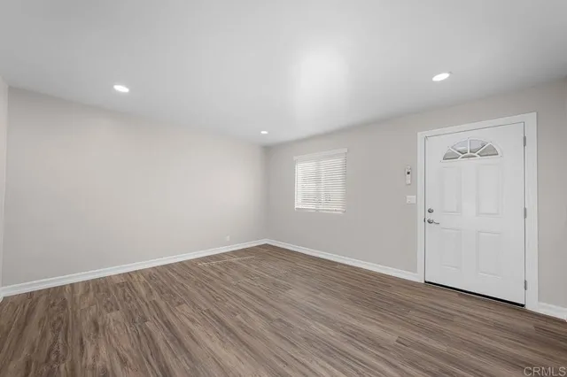 a view of room with window and wooden floor