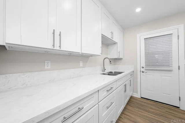a kitchen with a sink and cabinets