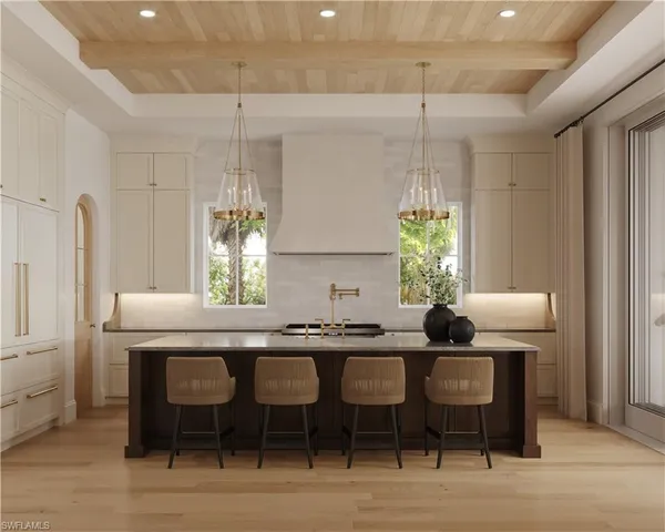 a kitchen with a dining table chairs and white cabinets