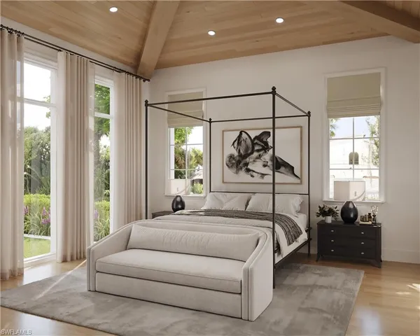 a bedroom with large bed and a window