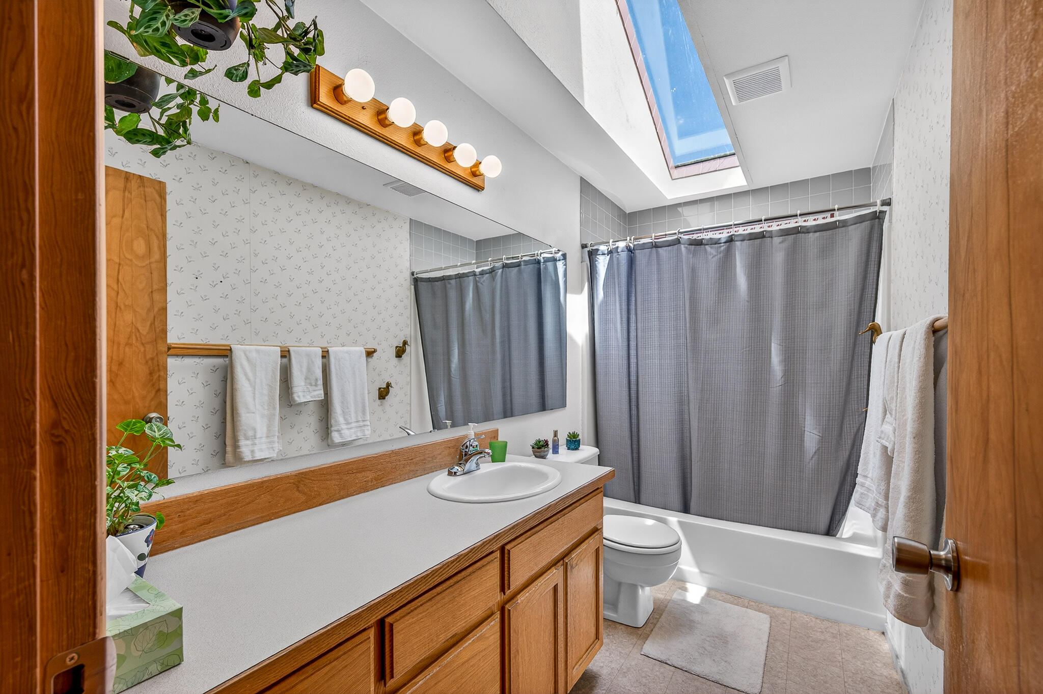 60866 Brosterhous Road Bend, OR 97702 - Photo 22 of 41 a bathroom with a sink a toilet and shower curtain