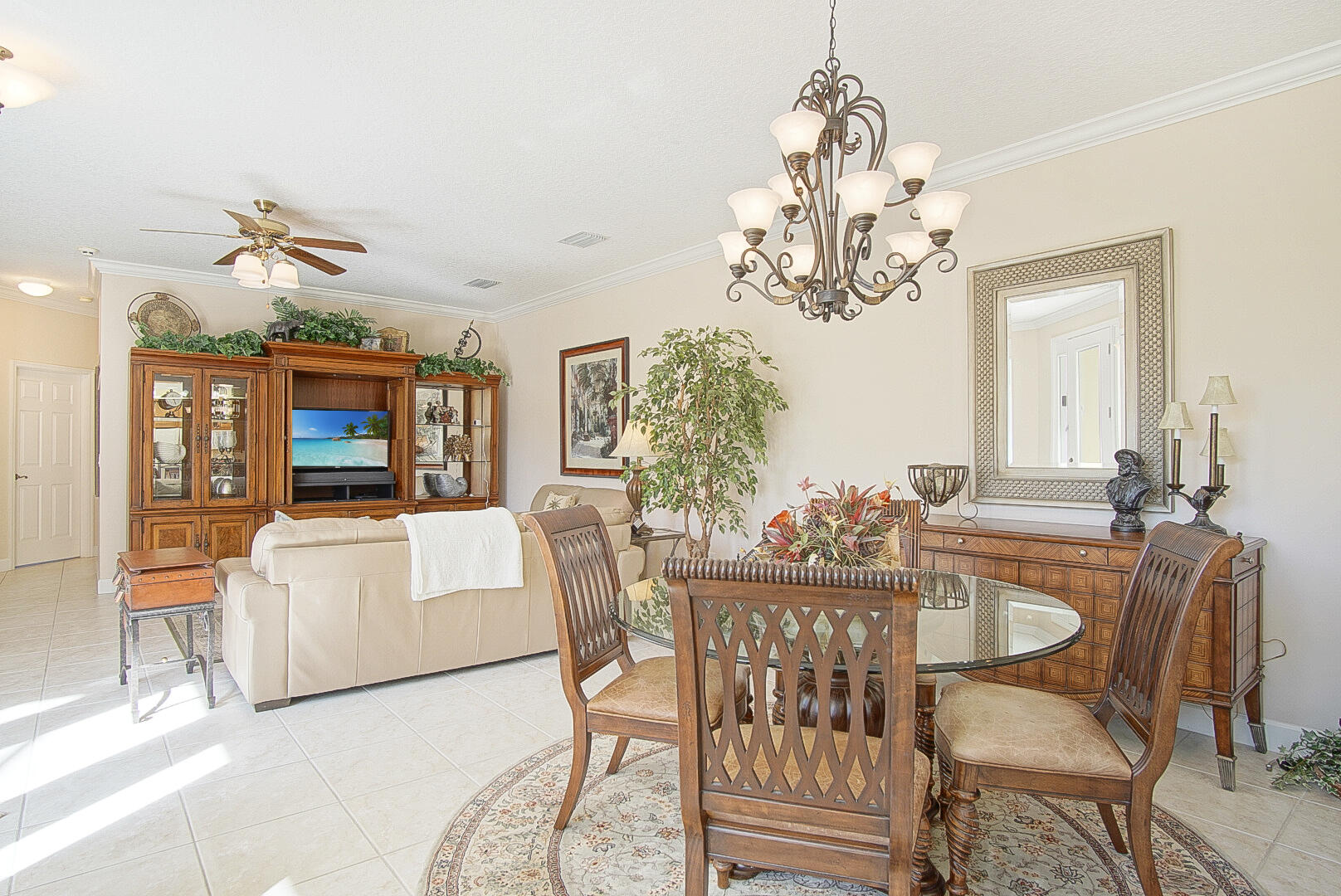 204 River Walk Fort Pierce, FL 34949 - Photo 11 of 30 a dining room with wooden floor a chandelier a wooden table and chairs