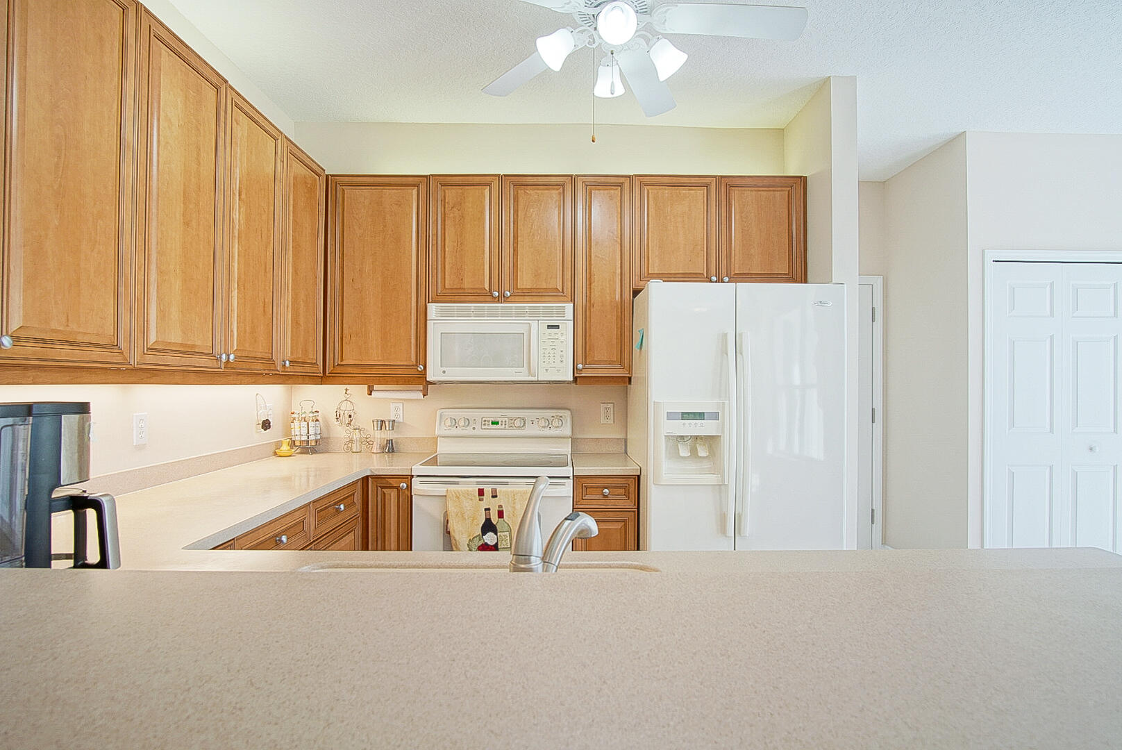 204 River Walk Fort Pierce, FL 34949 - Photo 17 of 30 a kitchen with stainless steel appliances granite countertop a refrigerator a sink and white cabinets