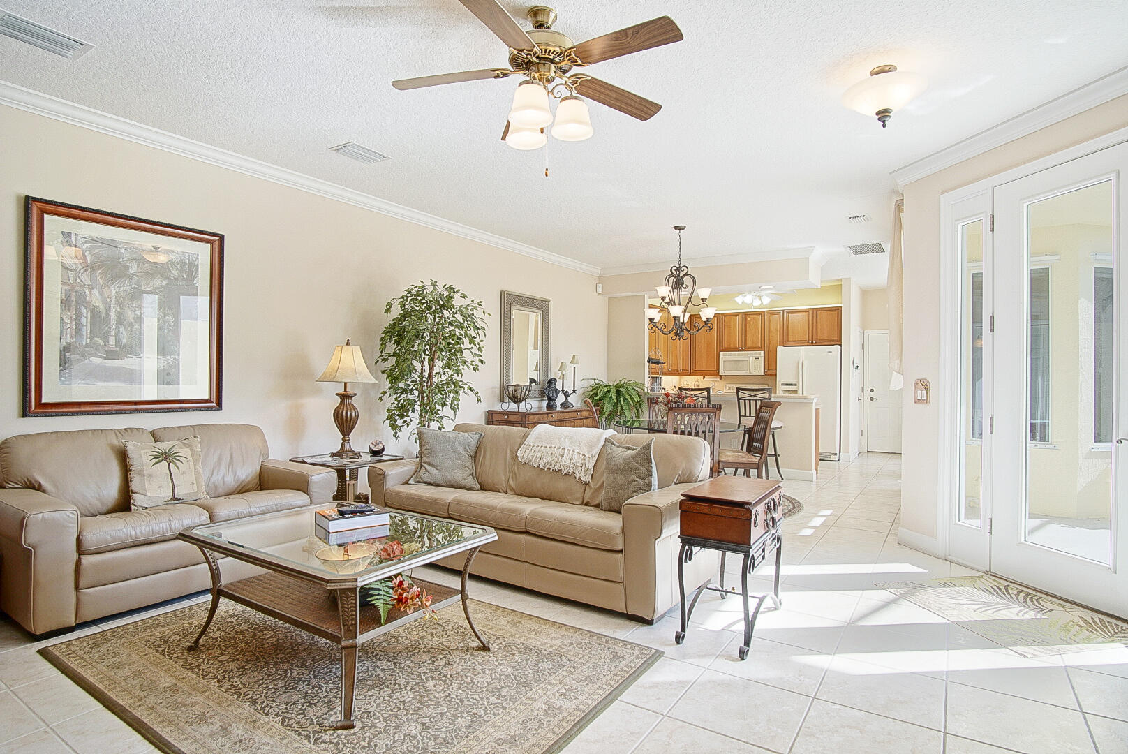 204 River Walk Fort Pierce, FL 34949 - Photo 9 of 30 a living room with furniture a table and a painting on the wall
