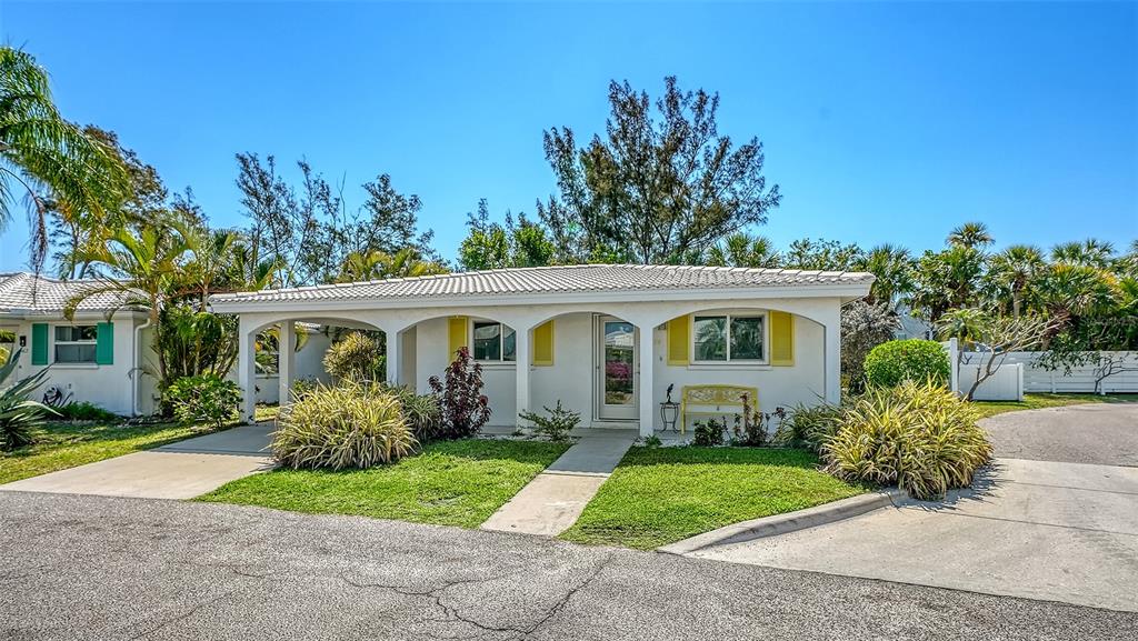 554 Spanish Drive South Longboat Key, FL 34228 - Photo 1 of 72 a front view of a house with garden