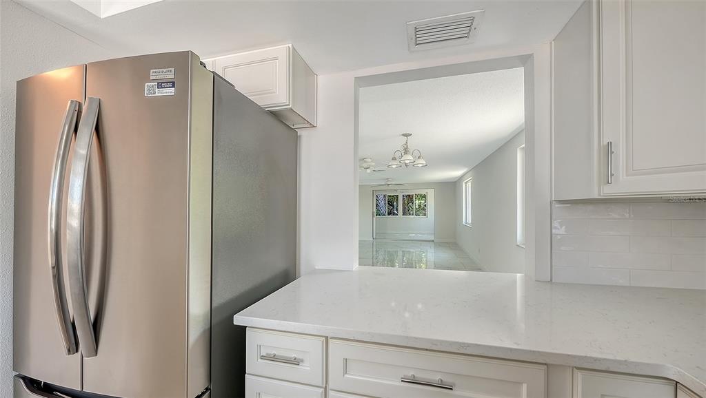 554 Spanish Drive South Longboat Key, FL 34228 - Photo 13 of 72 a view of kitchen with a refrigerator and cabinets