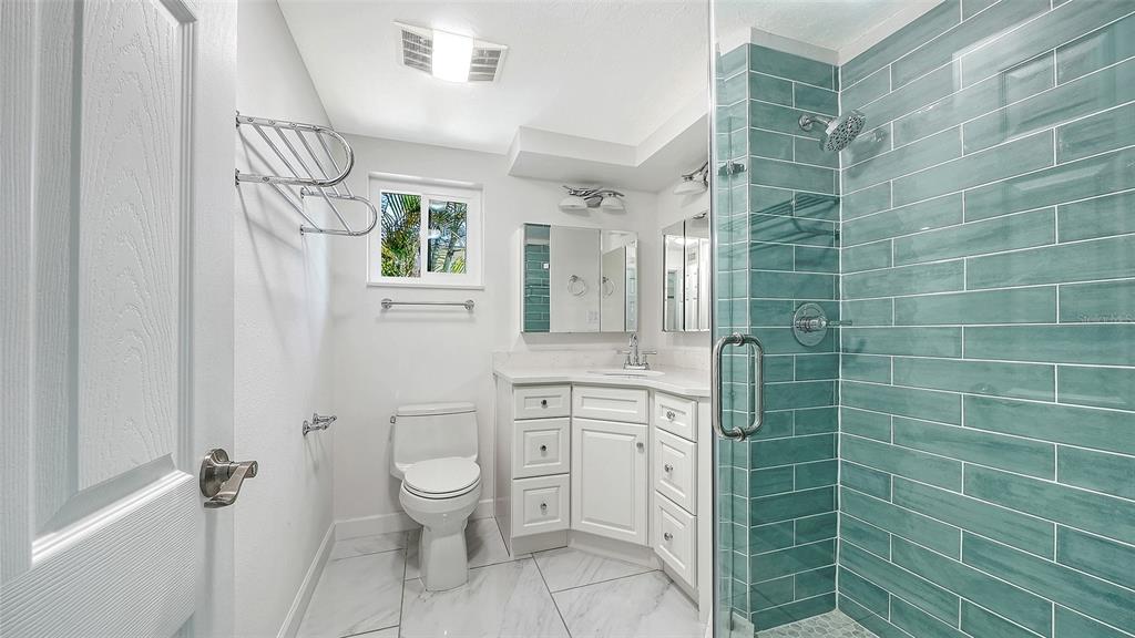 554 Spanish Drive South Longboat Key, FL 34228 - Photo 22 of 72 a bathroom with a shower toilet and sink