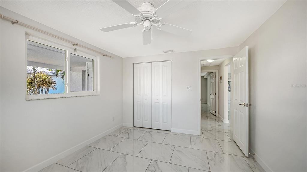 554 Spanish Drive South Longboat Key, FL 34228 - Photo 26 of 72 a view of an empty room with a fan