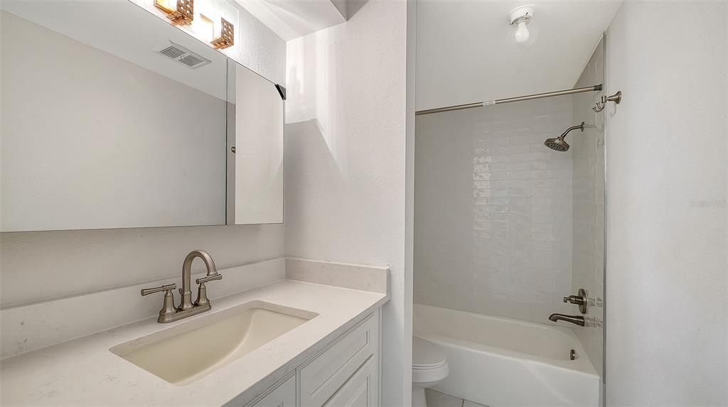 554 Spanish Drive South Longboat Key, FL 34228 - Photo 27 of 72 a bathroom with a sink a mirror and a bathtub