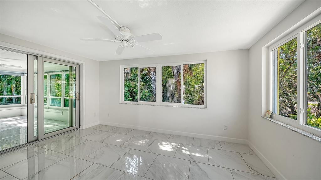 554 Spanish Drive South Longboat Key, FL 34228 - Photo 28 of 72 a view of an empty room with windows and pool
