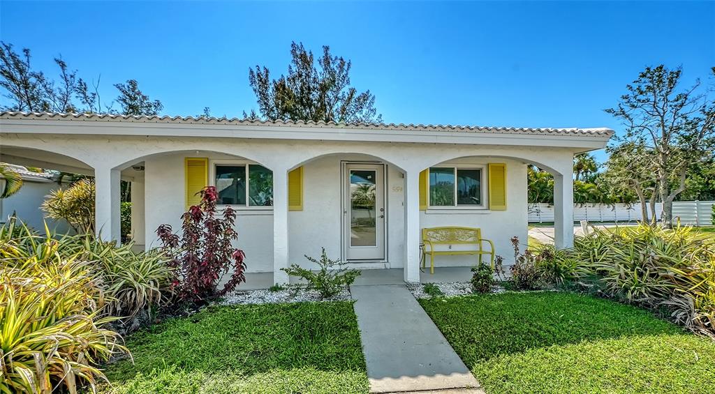 554 Spanish Drive South Longboat Key, FL 34228 - Photo 4 of 72 a front view of a house with garden