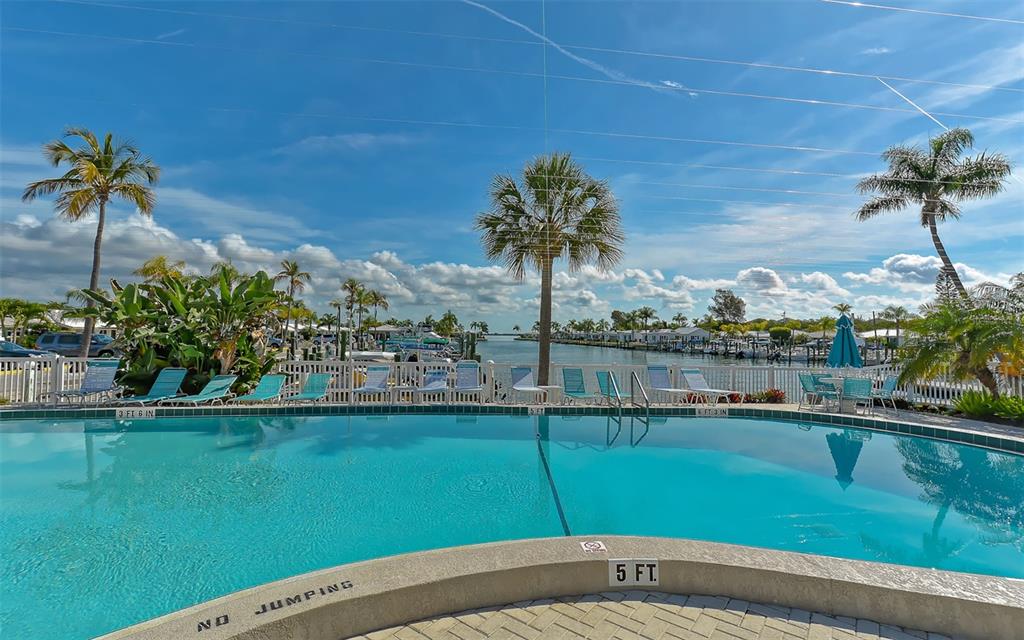 554 Spanish Drive South Longboat Key, FL 34228 - Photo 43 of 72 a view of a terrace with a garden