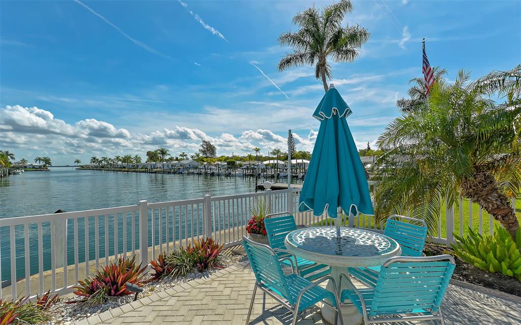 554 Spanish Drive South Longboat Key, FL 34228 - Photo 45 of 72 a view of a lake with a table and chairs
