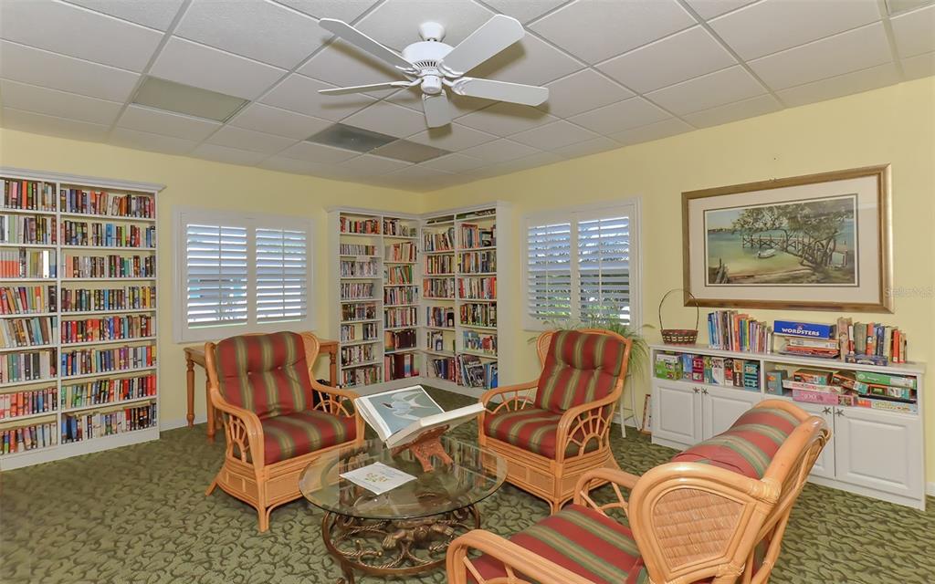 554 Spanish Drive South Longboat Key, FL 34228 - Photo 51 of 72 a living room with furniture and a floor to ceiling window