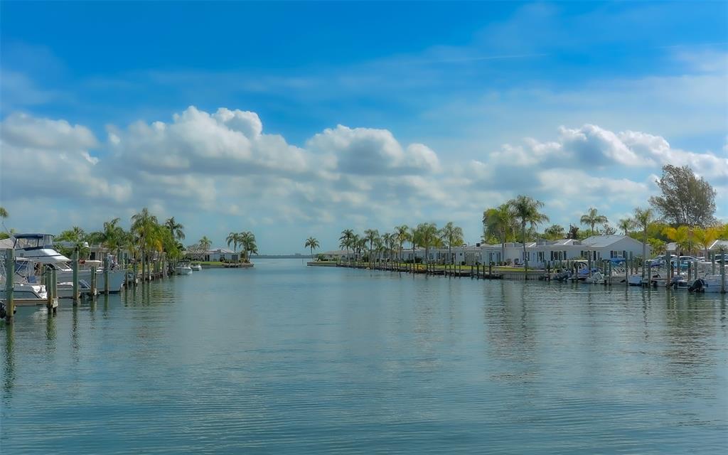 554 Spanish Drive South Longboat Key, FL 34228 - Photo 57 of 72 a view of an ocean with boats and trees in the background
