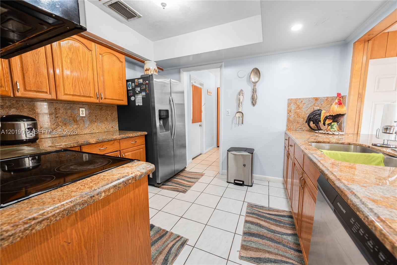 731 Northwest 17th Street Homestead, FL 33030 - Photo 8 of 29 a kitchen that has a sink a stove and a refrigerator