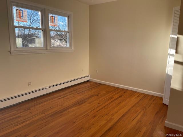 212 5th Avenue West Babylon, NY 11704 - Photo 13 of 17 an empty room with wooden floor and windows