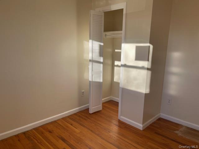 212 5th Avenue West Babylon, NY 11704 - Photo 14 of 17 wooden floor in an empty room