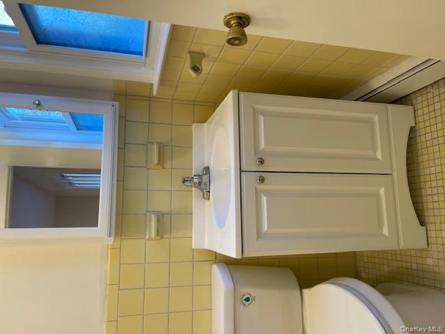 212 5th Avenue West Babylon, NY 11704 - Photo 15 of 17 a bathroom with a sink and a toilet