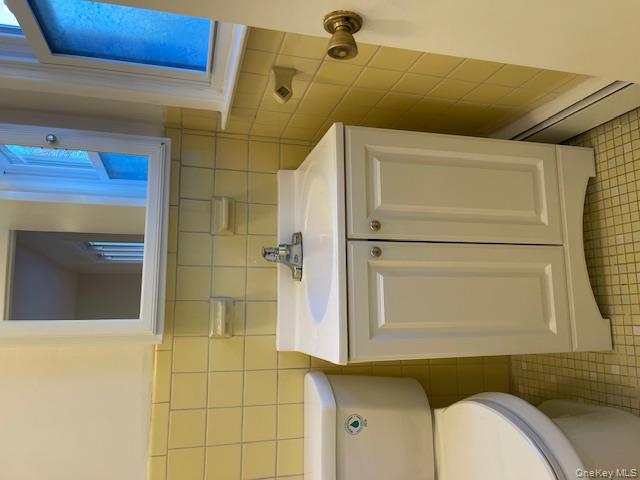 212 5th Avenue West Babylon, NY 11704 - Photo 16 of 17 a bathroom with a sink and a toilet