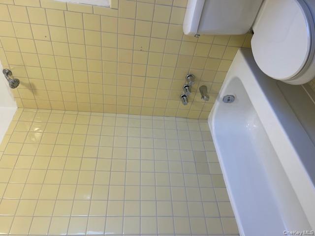 212 5th Avenue West Babylon, NY 11704 - Photo 17 of 17 a bathroom with a toilet and bathtub