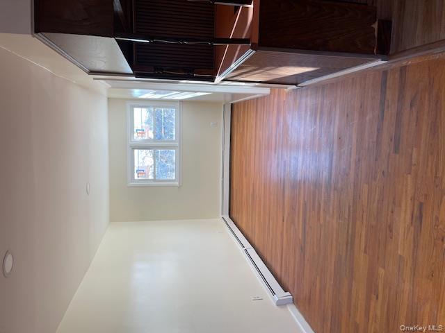 212 5th Avenue West Babylon, NY 11704 - Photo 5 of 17 a view of an empty room with wooden floor and a window