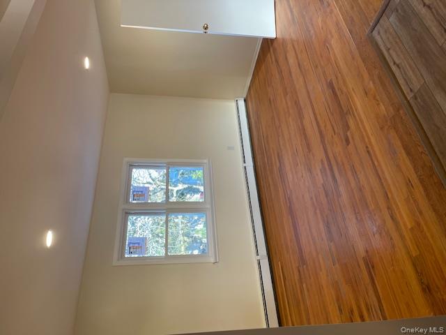 212 5th Avenue West Babylon, NY 11704 - Photo 6 of 17 an empty room with wooden floor and windows