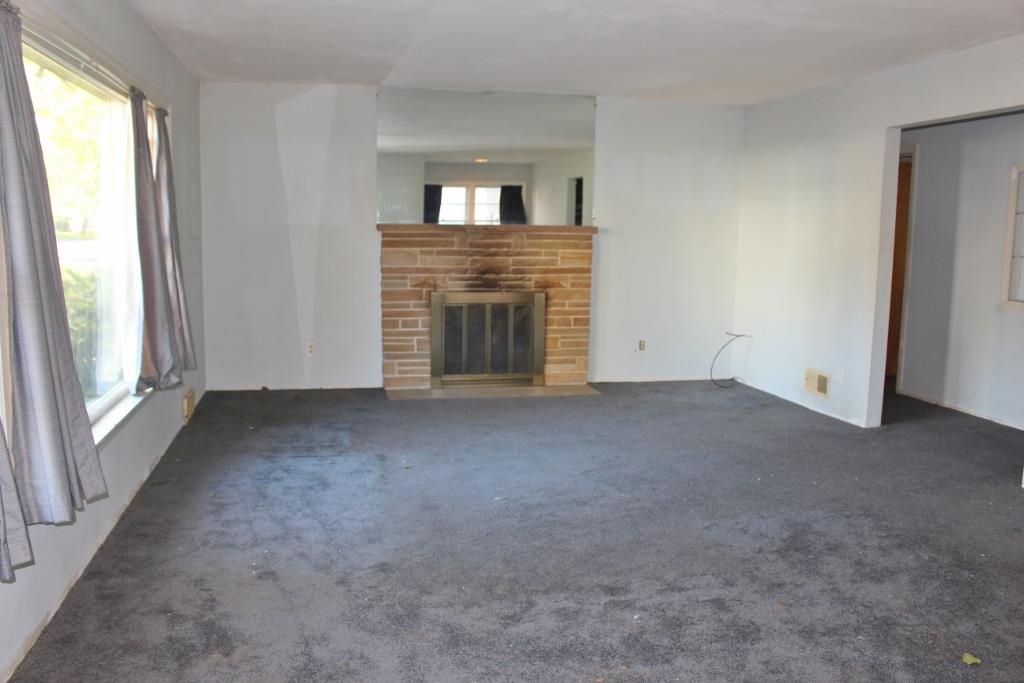 316 West Perry Street Belvidere, IL 61008 - Photo 2 of 21 a view of empty room with a fireplace