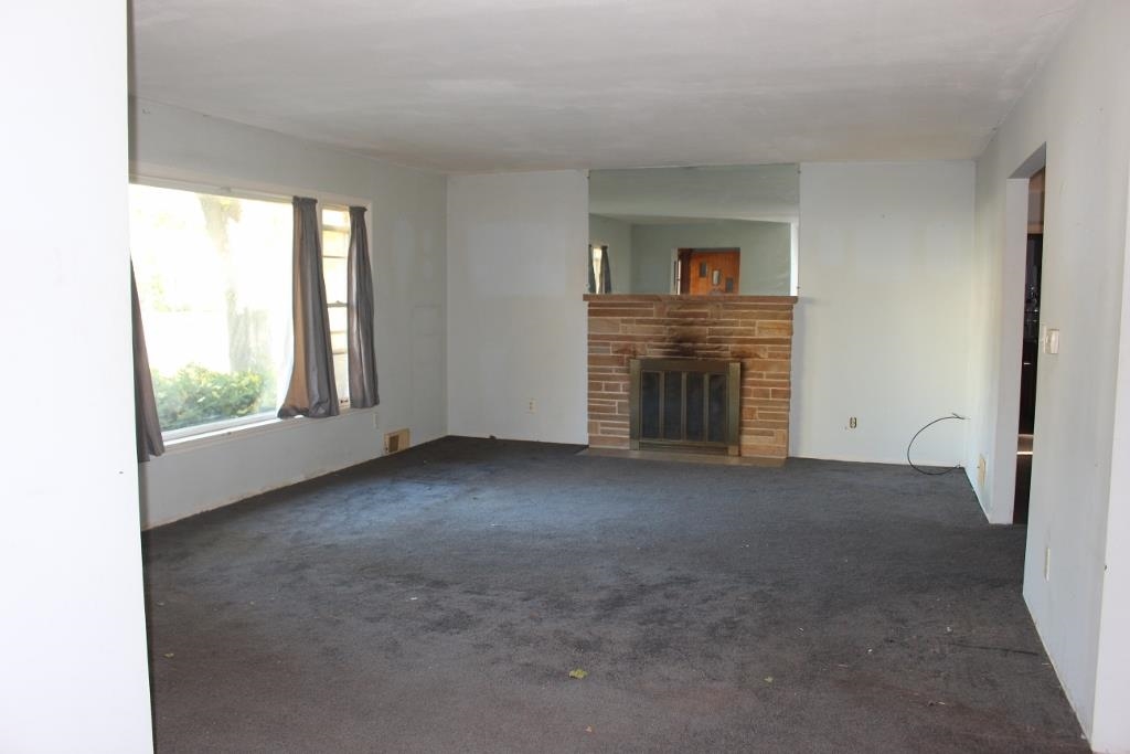 316 West Perry Street Belvidere, IL 61008 - Photo 3 of 21 a view of empty room with a fireplace