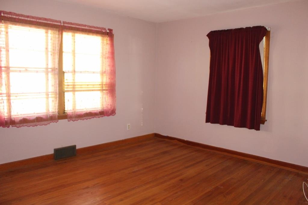 316 West Perry Street Belvidere, IL 61008 - Photo 6 of 21 an empty room with wooden floor and windows