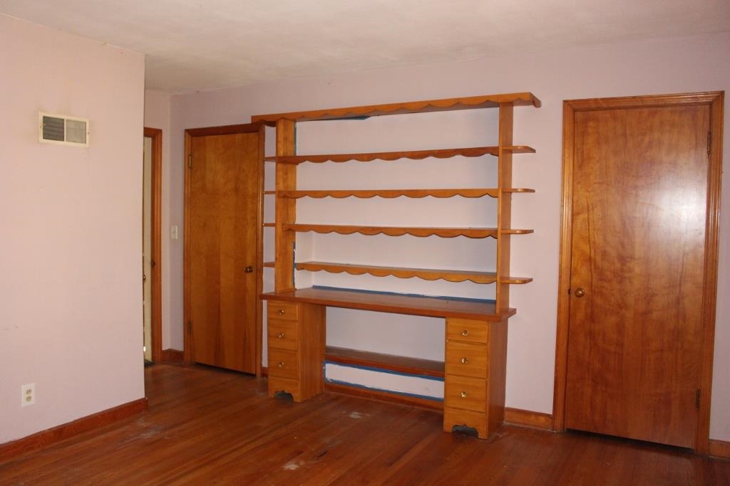 316 West Perry Street Belvidere, IL 61008 - Photo 7 of 21 a view of an empty room with wooden floor and a window