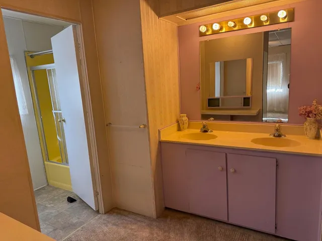 a bathroom with a double vanity sink and a mirror