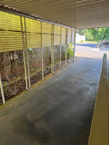 a view of a room with wooden floor and iron stairs