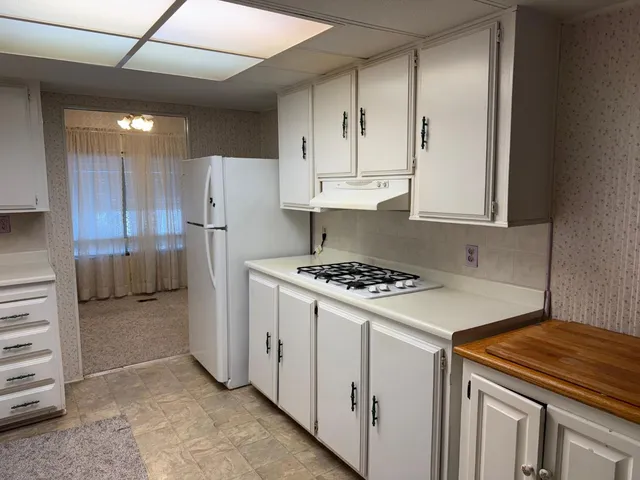 a kitchen with cabinets and appliances